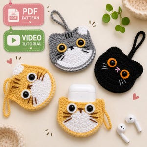 May include: Three crocheted cat-shaped pouches with loops, featuring black plastic eyes and embroidered whiskers. One pouch is gray and white, one is yellow and white, and one is solid black. A white wireless earbud case is inside the yellow pouch.