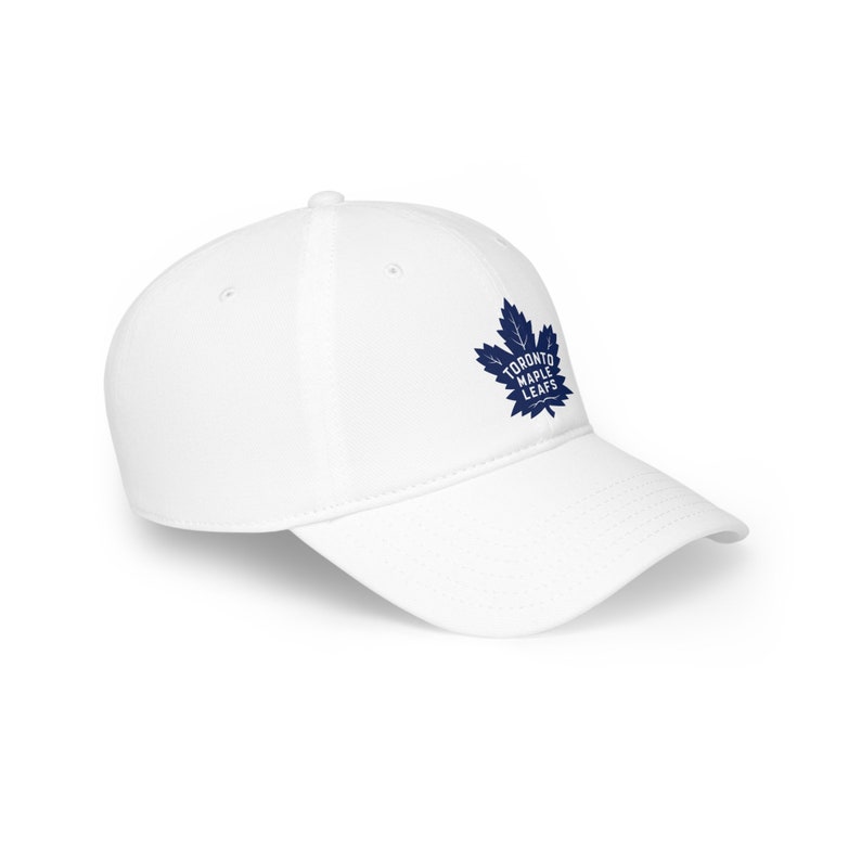 May include: White baseball cap with a blue Toronto Maple Leafs logo featuring a stylized maple leaf.