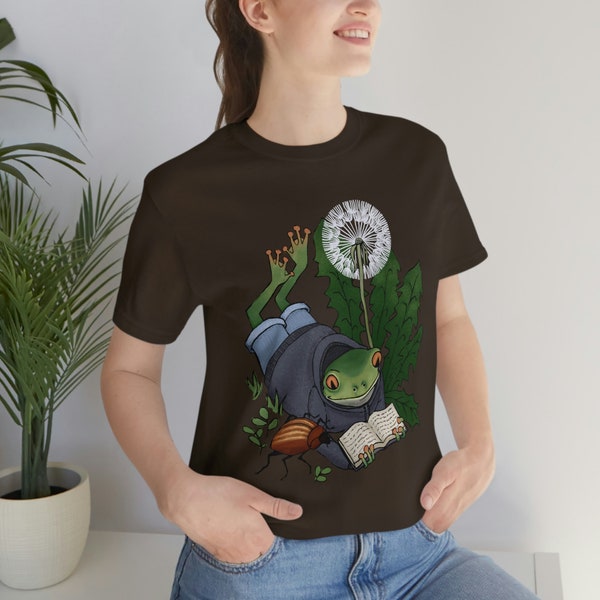 Little green frog reading a book with a beetle under a dandylion puff tee unisex t-shirt