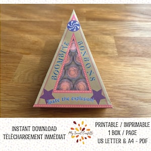 Może przedstawiać: Drukowany szablon pudełka do robienia pudełek na cukierki. Pudełko ma kształt trójkąta z gwiazdą po każdej stronie. Pudełko jest ozdobione napisami "Boombit'e Bonbons" i "Smak eksplozji!" w fantazyjnym kroju pisma. Pudełko jest przeznaczone do przechowywania małych okrągłych cukierków.