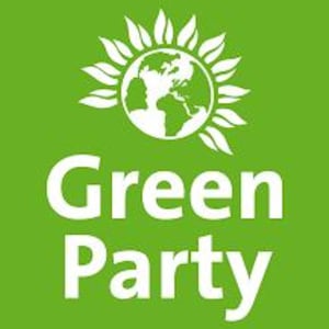 May include: A green square with the words "Green Party" in white, bold lettering. Above the text is a white graphic of the Earth encircled by a sunburst design. The image has a clean, modern aesthetic.
