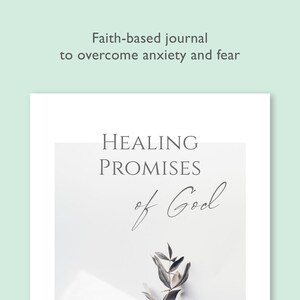 May include: A white journal cover with the text "HEALING PROMISES of God" in gray text. A small sprig of greenery is in the bottom right corner of the image.