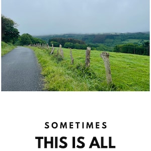 May include: A winding road leads through a green field with a wooden fence and a cloudy sky. The text "SOMETIMES THIS IS ALL YOU NEED" is written in black letters on a white background.
