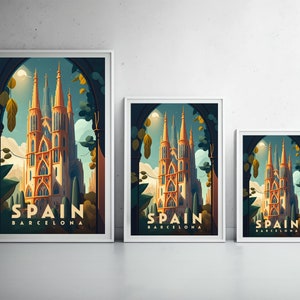 May include: Three framed prints with a vintage travel poster design featuring a tall, ornate building with the text "Spain Barcelona" at the bottom. The prints are in different sizes and are arranged in a row on a white wall.