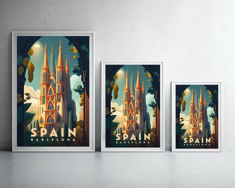 May include: Three framed prints with a vintage travel poster design featuring a tall, ornate building with the text "Spain Barcelona" at the bottom. The prints are in different sizes and are arranged in a row on a white wall.