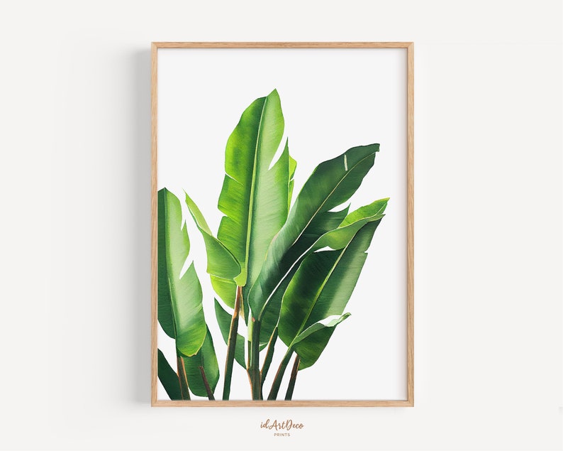 May include: A framed print of a watercolor painting of green tropical leaves against a white background.