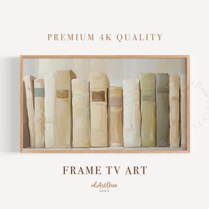 Pode incluir: Uma impressão emoldurada com uma coleção de livros em tons de creme, bege e verde oliva. A obra de arte é rotulada como "FRAME TV ART" e "PREMIUM 4K QUALITY". O logotipo idArtDeco também é visível.
