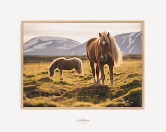 May include: Two brown horses graze in a field with a mountain range in the background. The horses are in a field of green grass with some patches of brown dirt. The sky is a light blue with some clouds.