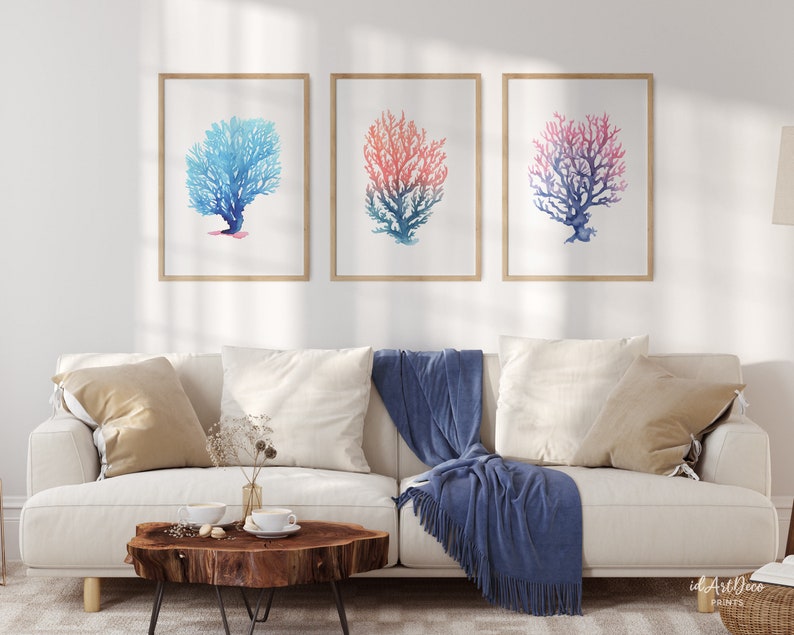 May include: Three watercolour prints of coral, each with a different colour gradient. The left print is blue, the middle print is pink and blue, and the right print is red and blue.