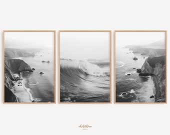 May include: A set of three black and white photographs featuring a dramatic ocean wave crashing against a rocky coastline. The images are framed in natural wood.