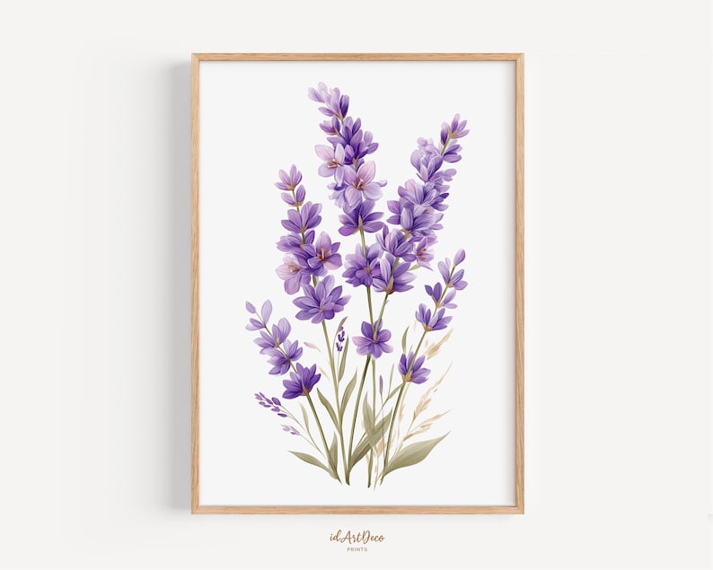 May include: A framed watercolor print of lavender flowers. The artwork features a cluster of purple lavender blooms with green stems and leaves, set against a white background. The frame is made of light-colored wood. The print is signed "id.ArtDeco Prints".