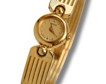 Raro y pequeño reloj Seiko de cuarzo para mujer, chapado en oro, de la década de 1990, con semi brazalete.