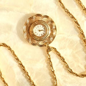 Vintage Caravelle 7 Jewel Gold Tone Pendant Watch in Almost New Condition Brocaded Front Floral Design Mechanical Hand Wind Watch with chain