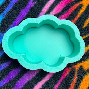 May include: A light green silicone mold shaped like a cloud. The mold is designed for making resin crafts.