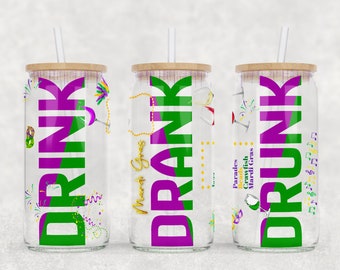 May include: Three clear glass tumblers with a purple and green design and the word "DRINK" in large letters. The tumblers have a wooden lid and a straw. The tumblers are decorated with Mardi Gras themed designs, including beads, masks, and music notes.