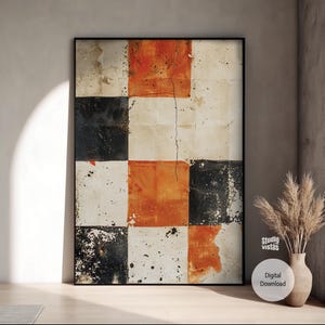 以下が含まれることがあります： 黒いフレームに入った抽象的なアートプリント。アートワークは、黒、オレンジ、オフホワイトの正方形のグリッドを特徴としています。画像は、中央に垂直のひび割れがあり、使い古された質感の外観をしています。右下の白い円には「デジタルダウンロード」と書かれています。