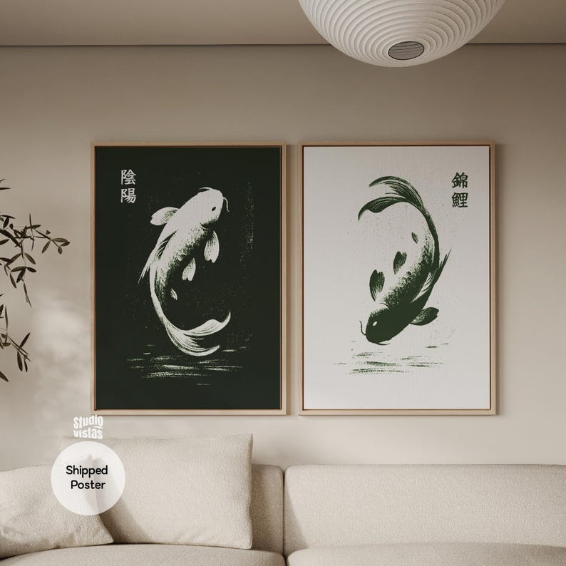 May include: Two framed art prints featuring koi fish. One print has a white koi on a dark green background, the other has a dark green koi on a white background. Japanese characters are above each fish. The prints are displayed above a sofa.