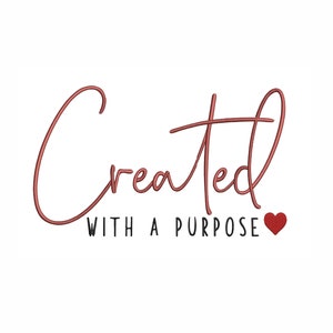 May include: A red cursive word "Created" with the words "with a purpose" below it and a small red heart to the right.