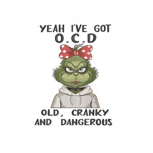 May include: Embroidered image of a green character with a red and white polka dot bow, wearing a gray hoodie. Text above reads "YEAH I'VE GOT O.C.D." and below, "OLD, CRANKY AND DANGEROUS."