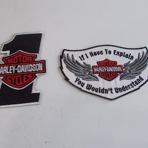 May include: Two embroidered Harley-Davidson patches. The first patch is black with a white outline and features the Harley-Davidson logo with the number "1" above it. The second patch is white with a gray outline and features the Harley-Davidson logo with the text "If I Have To Explain You Wouldn't Understand".