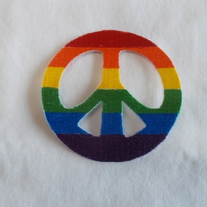 May include: A rainbow peace sign patch with red, orange, yellow, green, blue, indigo, and violet stripes.