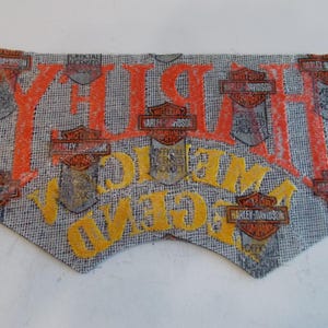 May include: A Harley-Davidson patch with orange and yellow lettering on a gray background. The patch features the Harley-Davidson logo and the words "Harley" and "Welcome". The patch is an official licensed product.