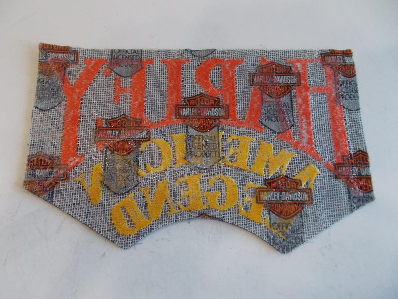 May include: A Harley-Davidson patch with orange and yellow lettering on a gray background. The patch features the Harley-Davidson logo and the words "Harley" and "Welcome". The patch is an official licensed product.