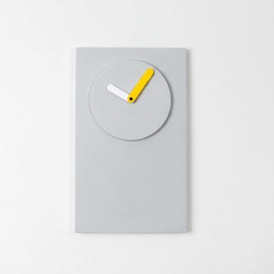 May include: A rectangular light grey wall clock featuring a circular face integrated into the upper portion. The clock has two hands, one shorter white hand and one longer yellow hand, both attached to a central black pivot point on the face.