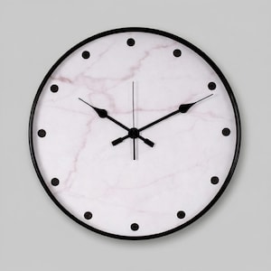 May include: A round wall clock with a black frame and hands. The clock face has a white marble design with pink veining and black dot hour markers. The clock's hands are black.