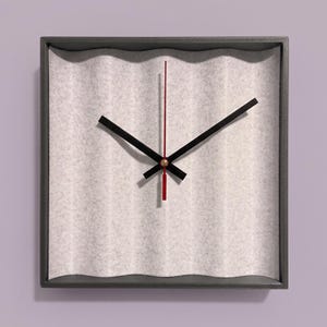 May include: A square wall clock with a dark grey frame and a light grey, vertically corrugated felt background. The clock features two black hour and minute hands and a thin, straight red second hand centred on a small metallic gold pin.