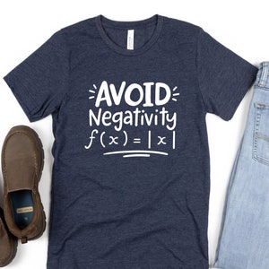 May include: A navy blue t-shirt with the text "AVOID Negativity f(x) = |x|" in white.