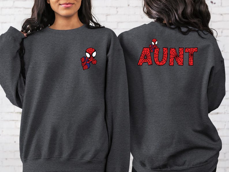 May include: Two dark grey sweatshirts with a Spiderman graphic. One sweatshirt has a small Spiderman graphic on the front and the other has the word "AUNT" spelled out in red with a Spiderman graphic in each letter on the back.
