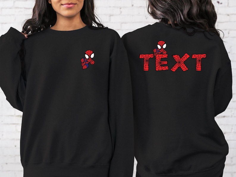 May include: Black sweatshirt with a small red and blue Spiderman graphic on the front and the word "TEXT" in red and blue Spiderman graphics on the back.