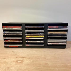 May include: A rustic wooden sign with the text "Welcome to our home" in a handwritten style. The sign features a distressed finish and a simple, inviting design, perfect for a front porch or entryway.