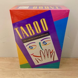 May include: A boxed Taboo game with a colorful design. The box features the word "TABOO" in yellow, a purple background, and a graphic of a face with a hand over the mouth. The text "THE GAME OF UNSPEAKABLE FUN!" is also visible.