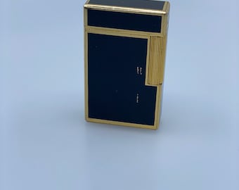 Vintage Bugatti lighter in black lacquer and gold plating, functional with signs of use