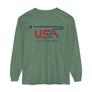 May include: A sage green long-sleeve shirt featuring a graphic on the back. The design includes a blue star, a stylized blue line, and the red text USA, with the words FLY CASTING printed in blue underneath the main graphic.