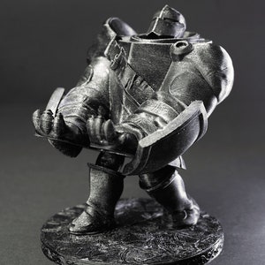 May include: A black and gray 3D printed figurine of a knight in armor, standing on a circular base with intricate details. The knight is in a defensive pose, with its arms raised and its shield in front of it.