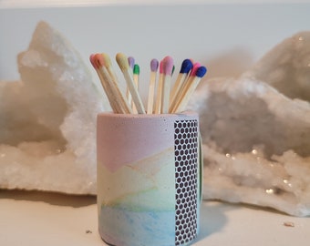 Rainbow colored matchsticks in handmade container