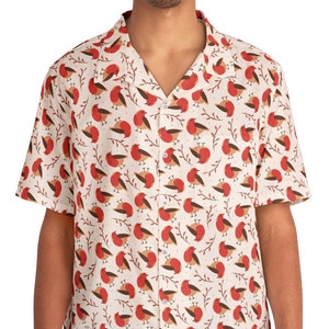 May include: A white short-sleeved button-down shirt with a red and brown bird pattern.