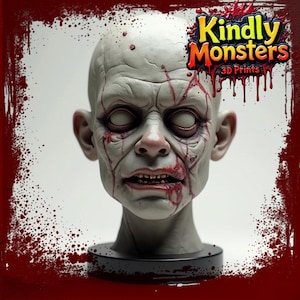 May include: A detailed, hand-painted, white and red zombie head bust. The bust is on a black base. The bust is a 3D print from Kindly Monsters 3D Prints.