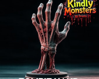 Puede incluir: Escultura de mano de zombi impresa en 3D, con detalles de músculos y huesos expuestos. La mano es de color gris pálido con acentos rojos, montada sobre una base circular negra. El texto "ZOMBIE HAND" se muestra en la parte inferior.