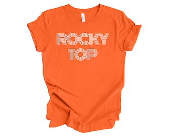 May include: Orange t-shirt with the text "ROCKY TOP" in white outlined letters.