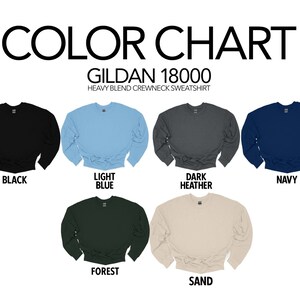 May include: Color chart for Gildan 18000 heavy blend crewneck sweatshirt in black, light blue, dark heather, navy, forest, and sand.