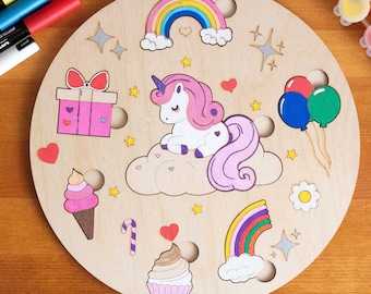 May include: A wooden round craft project with various shapes to paint. The shapes include a unicorn, a rainbow, a gift, a cupcake, ice cream, balloons, and stars.