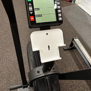 May include: A black Rogue Rower with a digital display showing the words "Intervals", "Targets", and "Heart Rate". The display has buttons for "Start", "Enter", and "Stop".