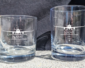 May include: Two clear glass tumblers with an airplane silhouette and the word "NAME" etched on the front. The smaller tumbler has "Line 1" and "Line 2" etched below the name.