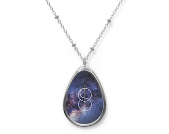 May include: A silver chain necklace with a teardrop-shaped pendant featuring a galaxy print and a white geometric design.