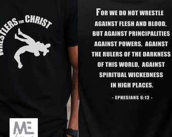 May include: Black t-shirt with a white silhouette of two wrestlers and the text "Wrestlers for Christ". The back of the shirt has a white text quote from Ephesians 6:12, "For we do not wrestle against flesh and blood, but against principalities, against powers, against the rulers of the darkness of this world, against spiritual wickedness in high places."