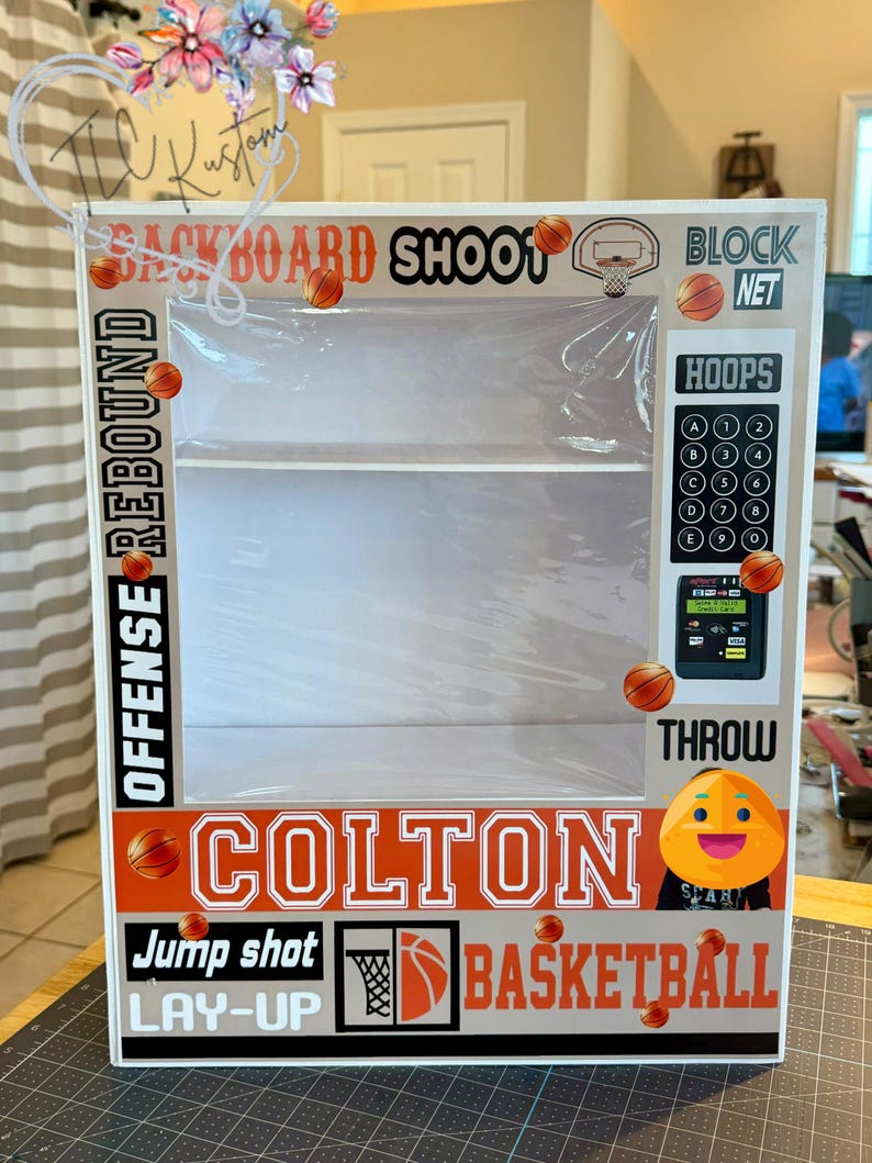 May include: A basketball-themed display box with the name "Colton" in bold letters. The box features basketball graphics, the words "Backboard Shoot", "Offense Rebound", "Block Net", "Hoops", "Jump Shot", "Lay-Up", and "Basketball".